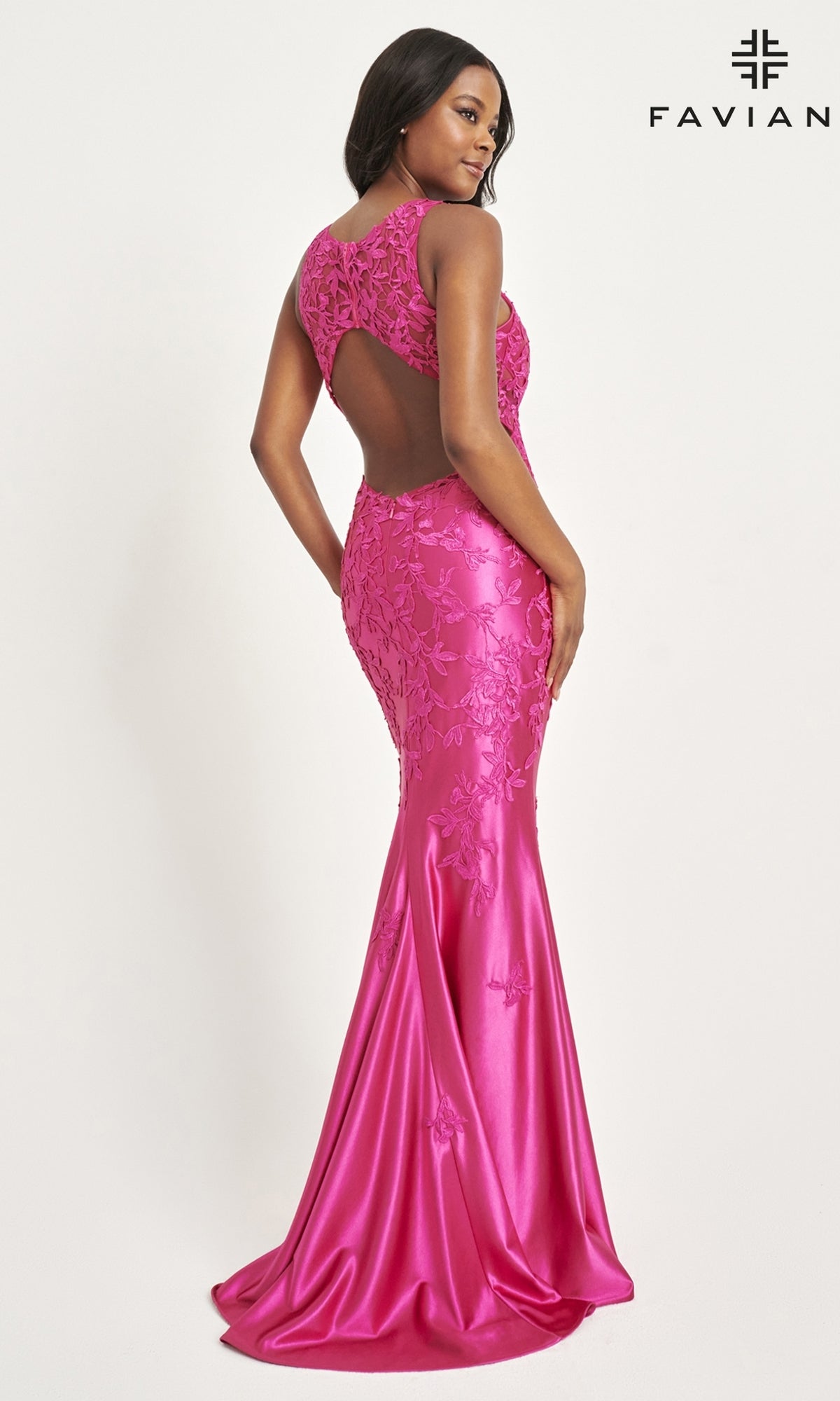Woman in a fitted, bright pink Faviana Tonal-Lace Long Prom Dress 11082 featuring floral lace details, stretch satin fabric, and an open back, standing against a white background.